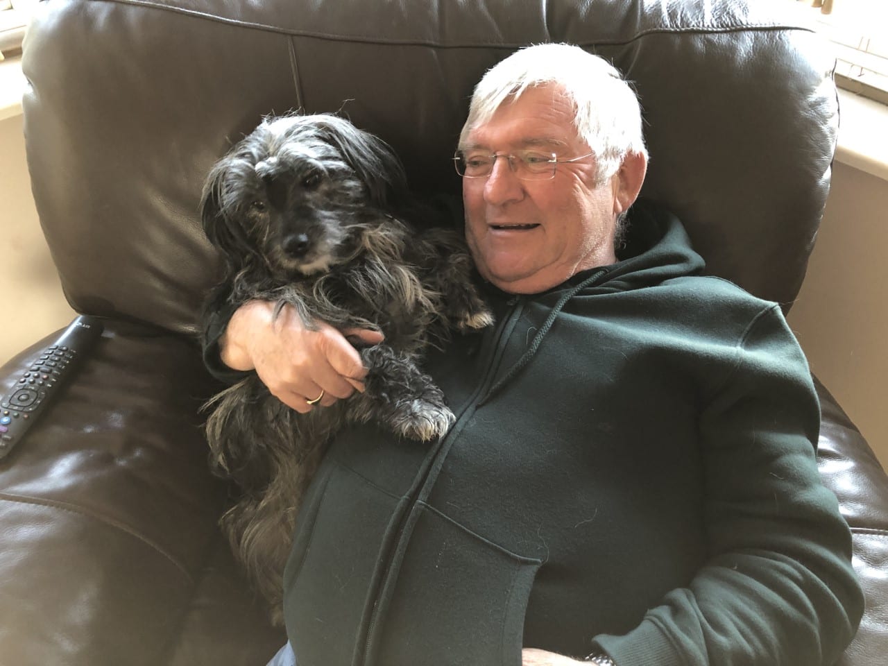 Harvey a scruffy Romanian rescue dog having a cuddle with his owner | 1 Dog At a Time Rescue UK